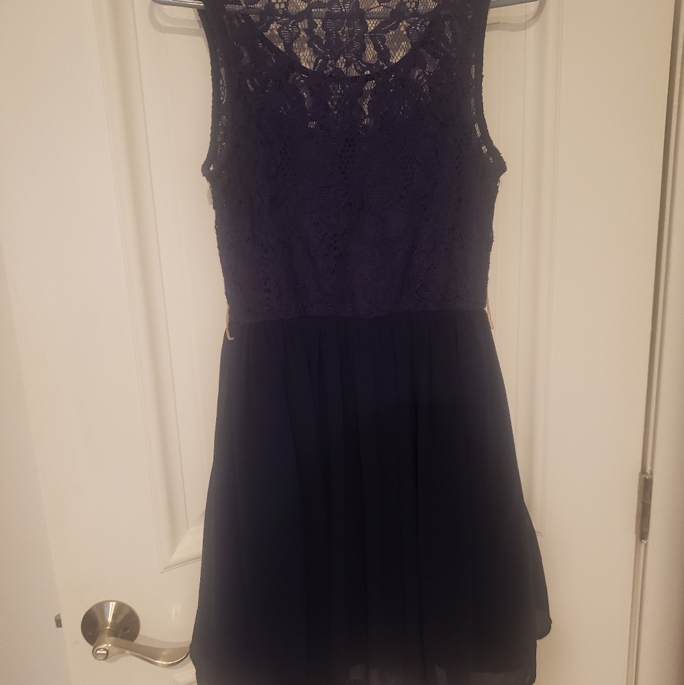 Dark blue cocktail dress with lace underskirt.